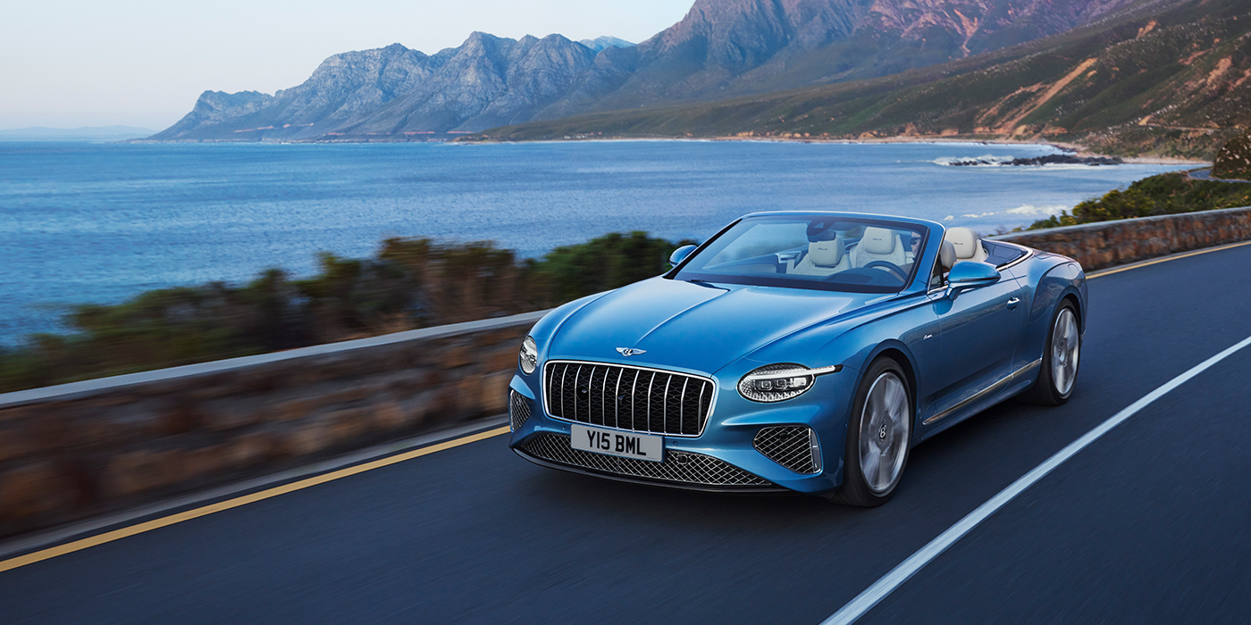 Bentley Istanbul New Bentley Continental GTC Azure convertible in Light Windsor blue paint with 22 inch Azure wheels and chrome grill, driving dynamically by the sea