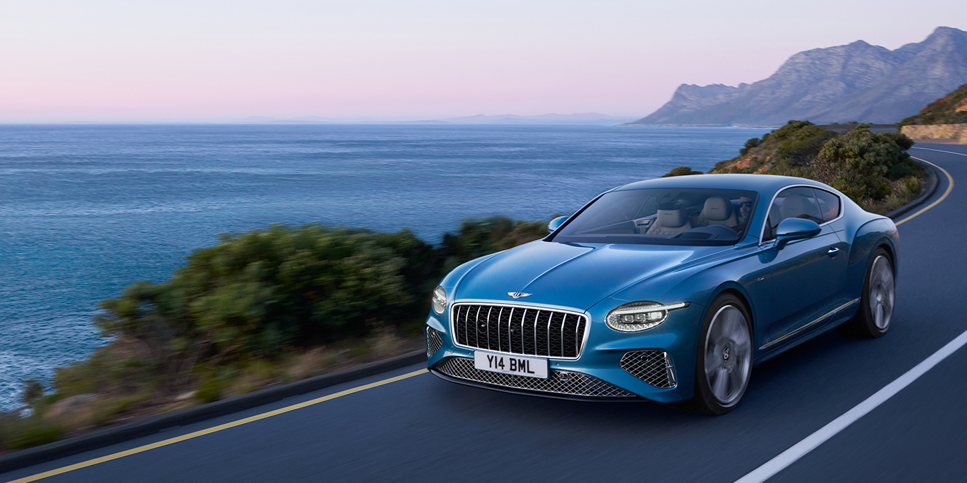 Bentley Istanbul New Bentley Continental GT Azure coupe in Light Windsor blue paint with 22 inch Azure wheels and chrome grill, driving dynamically by the sea