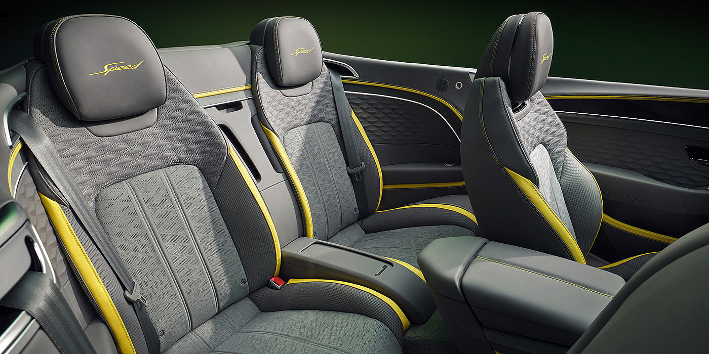 Bentley Istanbul Bentley New Continental GTC Speed convertible rear interior with unique Speed colour split in Gravity Grey and Cyber Yellow hide colours, and contrast stitched headrest emblems 