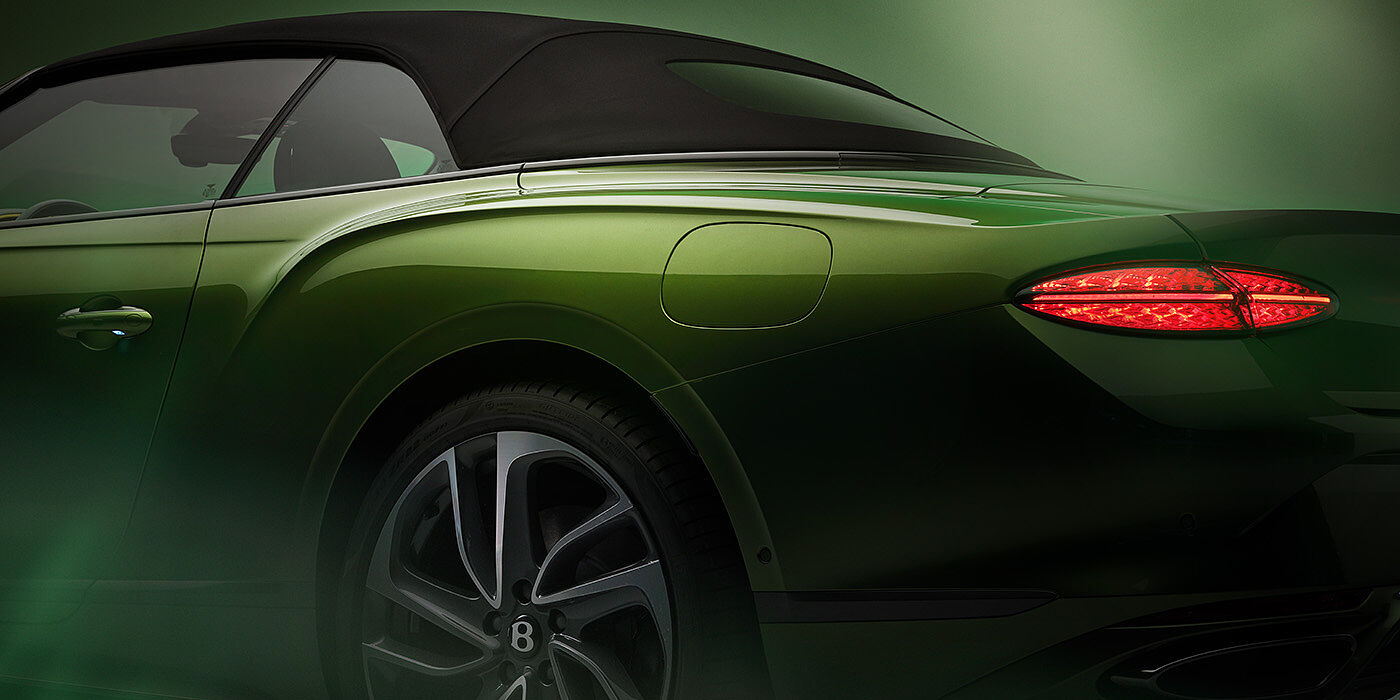 Bentley Istanbul Bentley New Continental GTC Speed rear haunch and tail lamp in Tourmaline Green paint and dark tint brightware with black hood up and illuminated head lamps