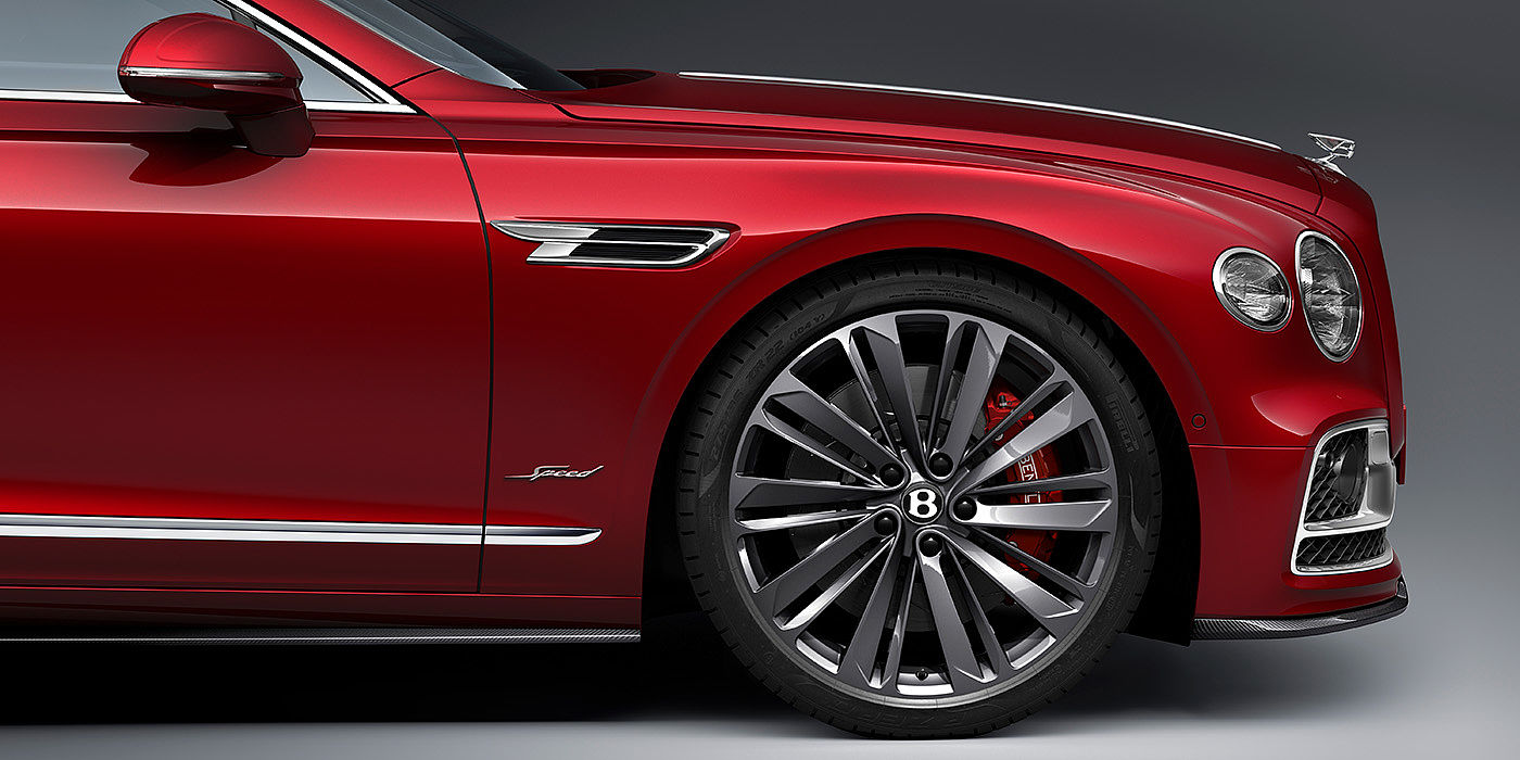 Bentley Istanbul Bentley Flying Spur Speed sedan front wheel in close up with Dragon Red II paint