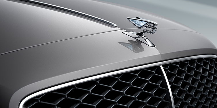 Bentley Istanbul New Bentley Flying Spur sedan bonnet detail in Silverlake paint with Illuminated Flying B bonnet badge and matrix grille with chrome surround